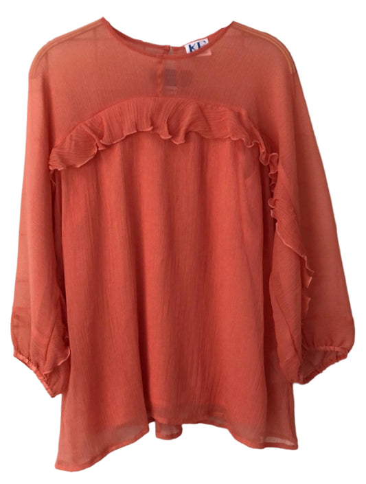 Coral-colored blouse with ruffled details